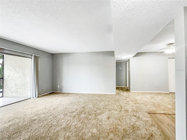 spare room featuring a textured ceiling, carpet, and ceiling fan