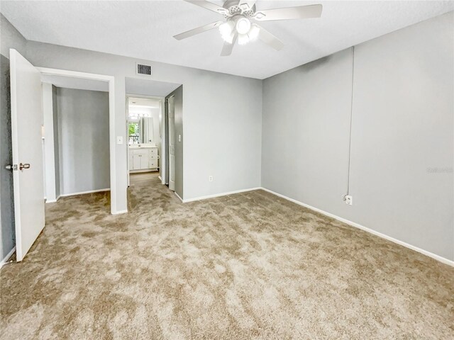 unfurnished bedroom featuring ceiling fan and light colored carpet