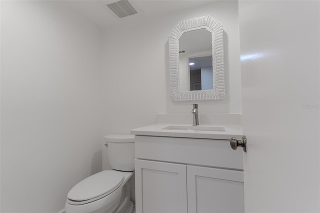 bathroom with visible vents, vanity, and toilet