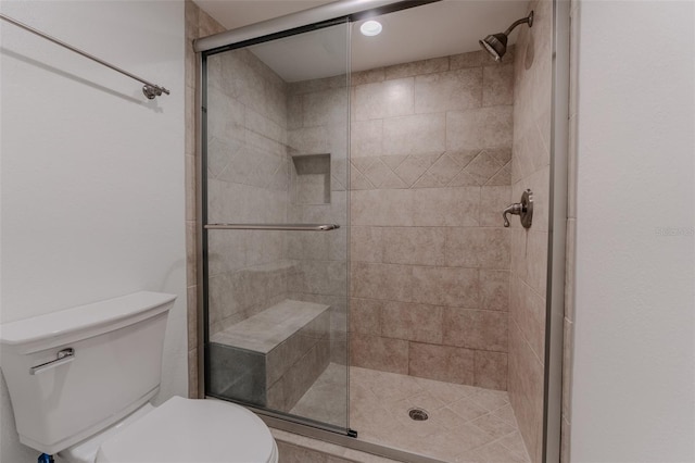 full bath featuring toilet and a stall shower