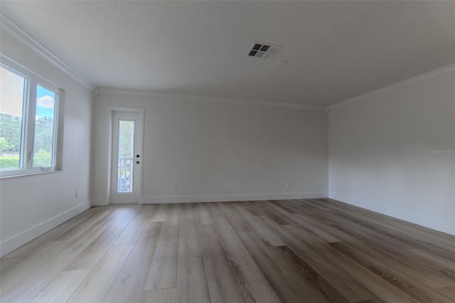 spare room featuring ornamental molding and wood-type flooring