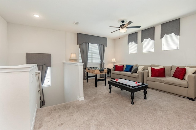 carpeted living room featuring ceiling fan