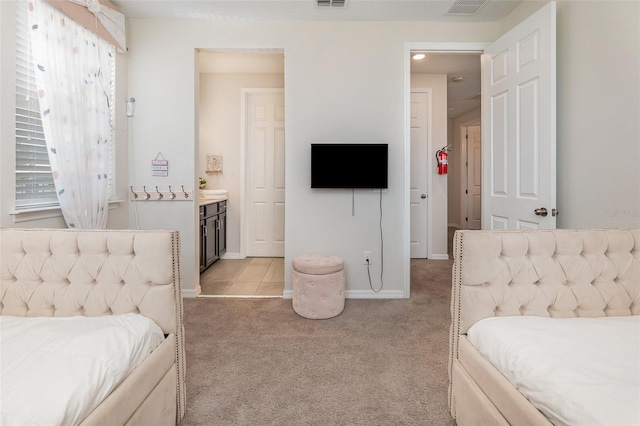 carpeted bedroom featuring ensuite bathroom