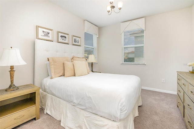 bedroom featuring carpet flooring and an inviting chandelier