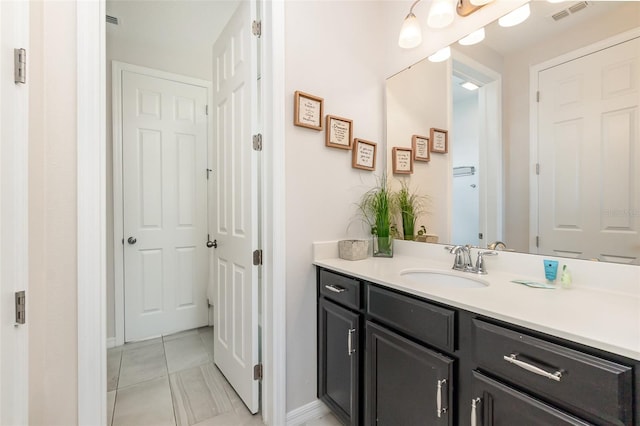 bathroom with tile patterned floors and vanity