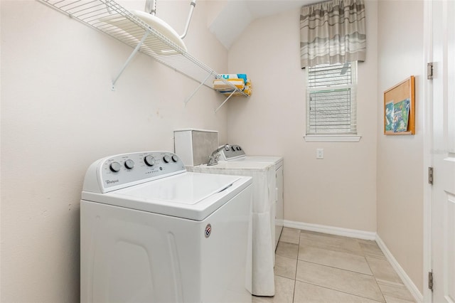 laundry room featuring light tile patterned floors and washer and dryer