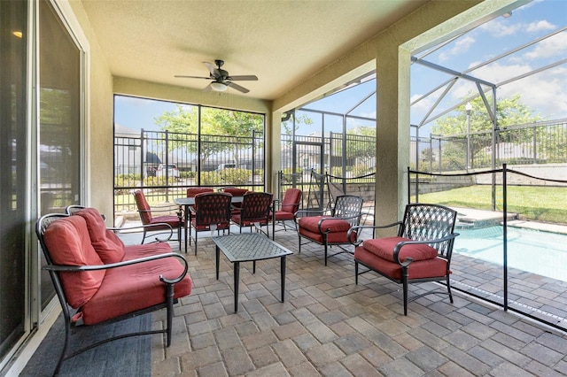 sunroom featuring ceiling fan