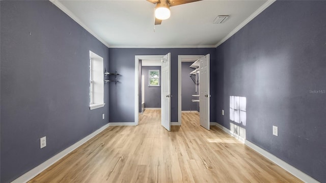 unfurnished bedroom featuring light hardwood / wood-style flooring, ceiling fan, and crown molding