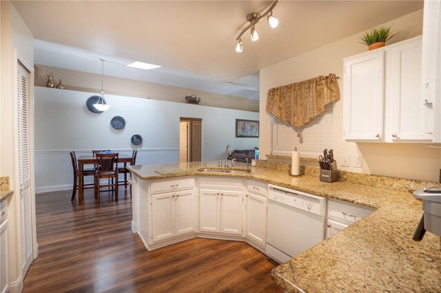 kitchen with sink, dishwasher, kitchen peninsula, and dark hardwood / wood-style floors