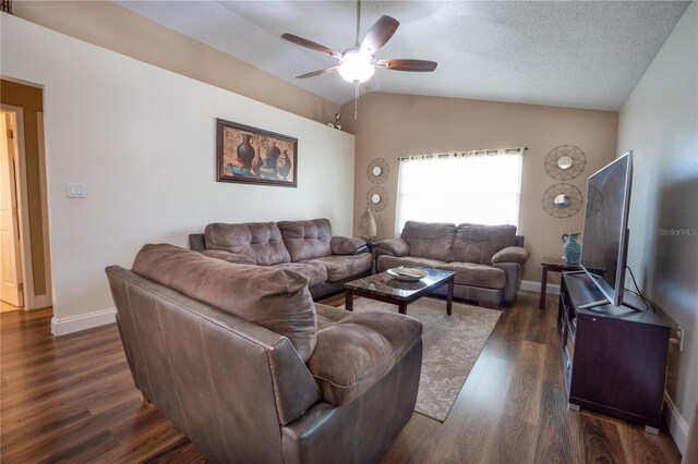 living room featuring dark wood-type flooring, a textured ceiling, vaulted ceiling, and ceiling fan