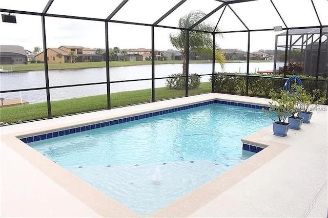 view of swimming pool featuring glass enclosure