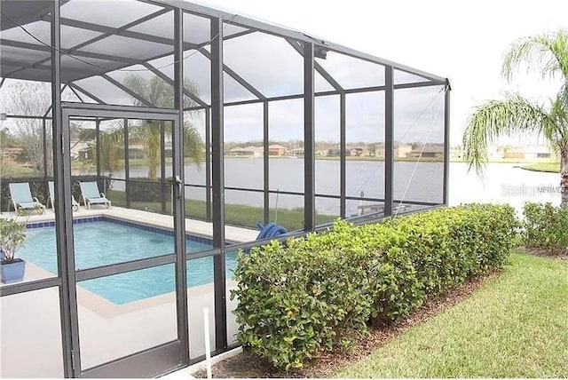 view of swimming pool featuring glass enclosure