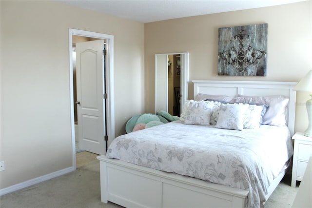 bedroom featuring light carpet