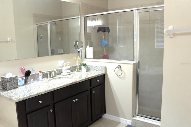 bathroom featuring a shower with door, tile patterned floors, and vanity