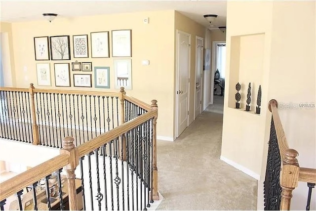 hallway with light colored carpet