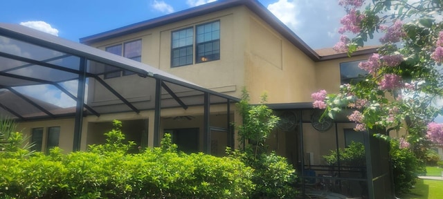 view of side of property with a lanai