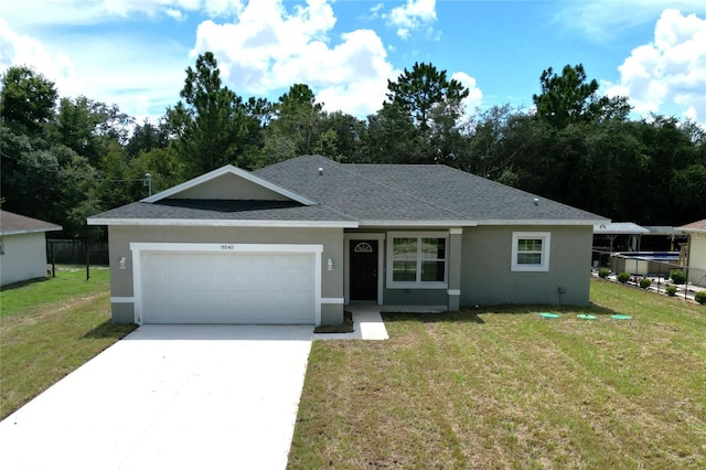 ranch-style home with a garage and a front lawn