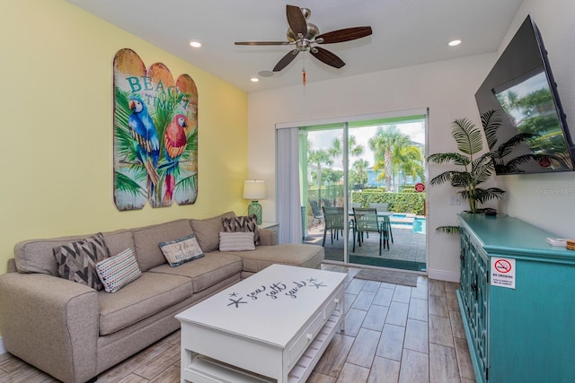 living room with light wood-type flooring and ceiling fan