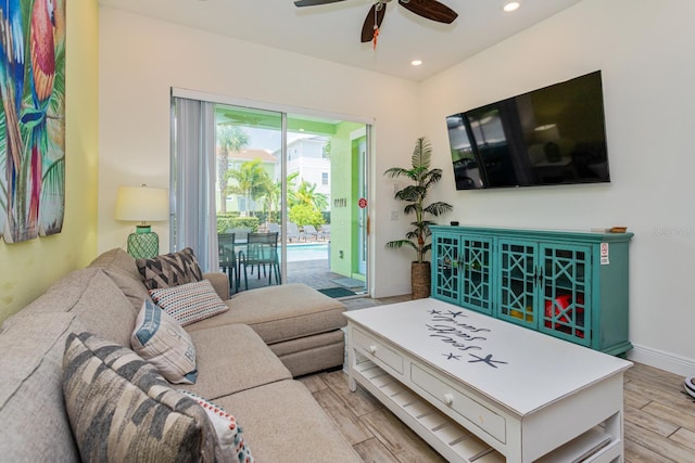 living room featuring light wood-type flooring and ceiling fan