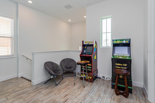 game room with light hardwood / wood-style flooring