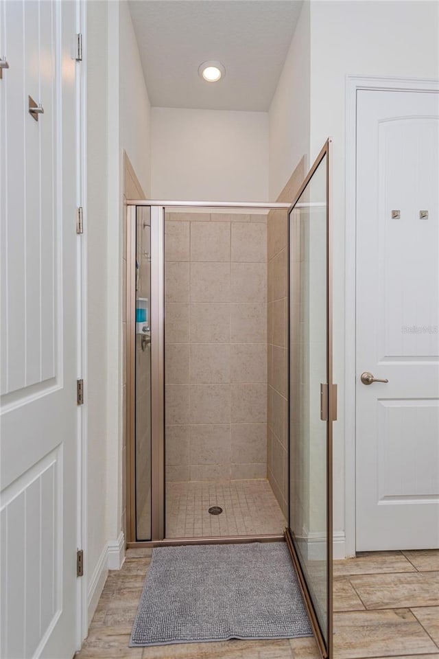 bathroom with a shower with door