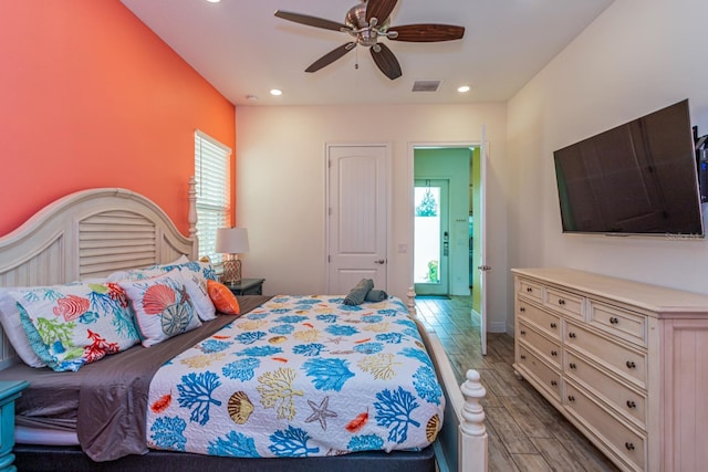 bedroom with light hardwood / wood-style flooring and ceiling fan