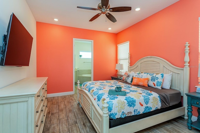 bedroom featuring connected bathroom, ceiling fan, and light hardwood / wood-style flooring