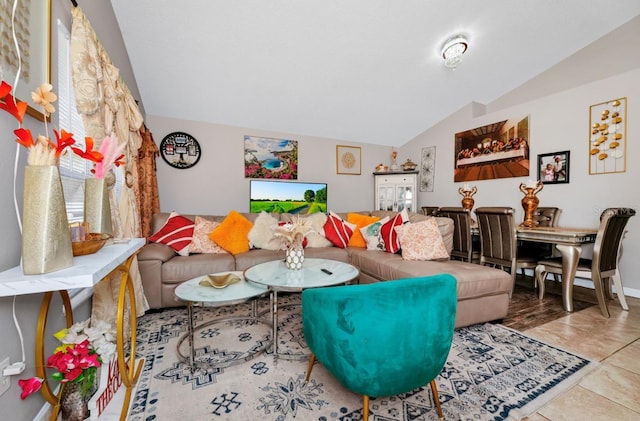 living area with tile patterned flooring and vaulted ceiling