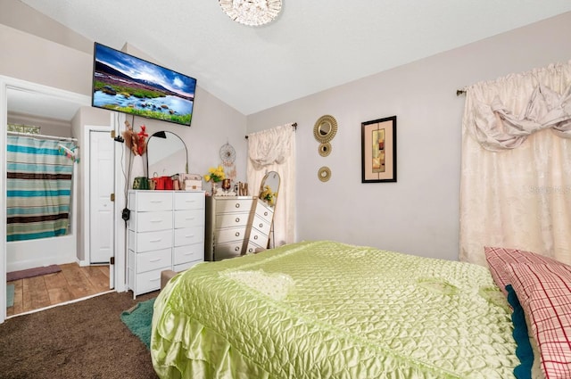 carpeted bedroom featuring lofted ceiling