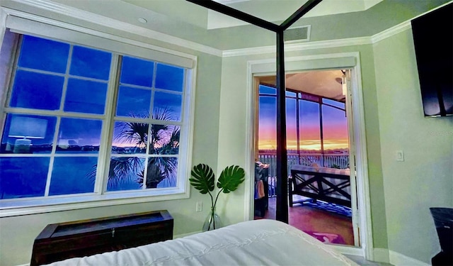 bedroom with baseboards and crown molding