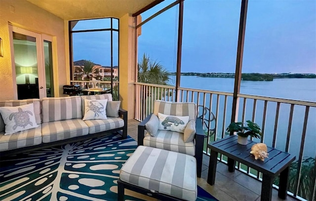 sunroom / solarium featuring a water view