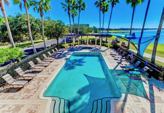 community pool with a patio, fence, and a pergola