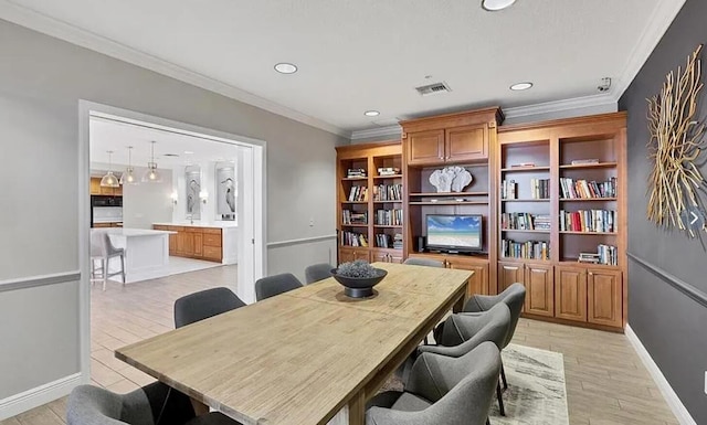 office featuring light wood finished floors, visible vents, crown molding, and recessed lighting