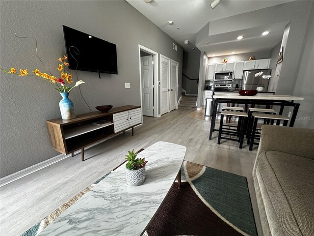 living room with light hardwood / wood-style flooring