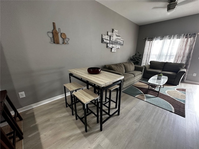 living area featuring baseboards and wood finished floors