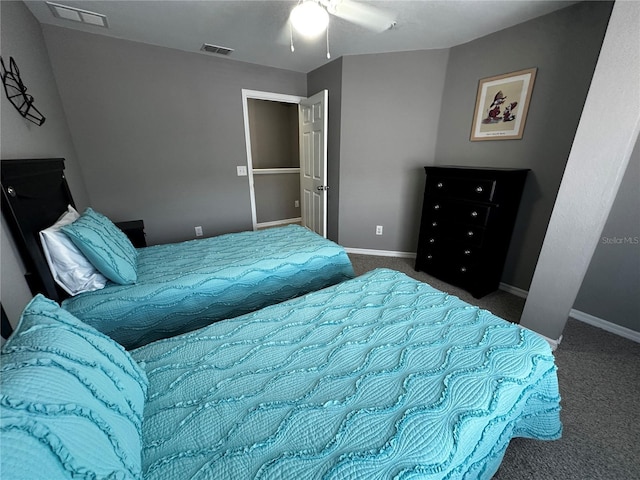 bedroom featuring visible vents, dark carpet, and baseboards