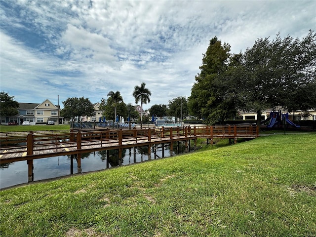 dock area featuring a lawn and a water view