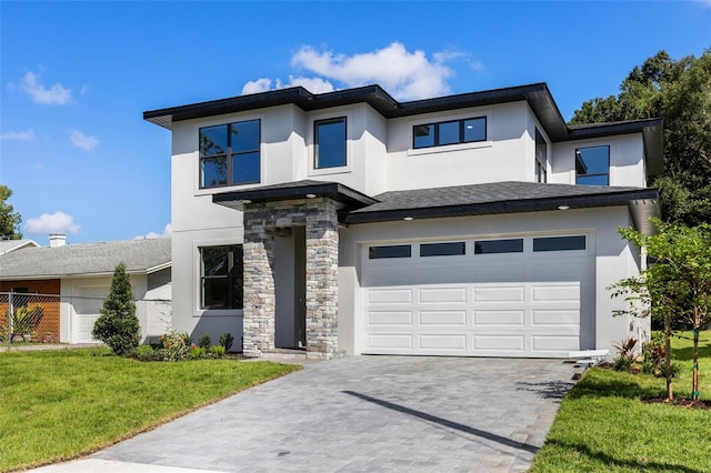 view of front of property featuring a garage and a front yard