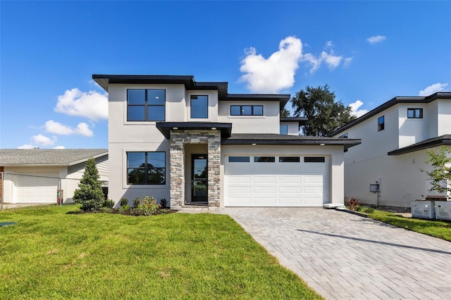 view of front of property with a front lawn and a garage