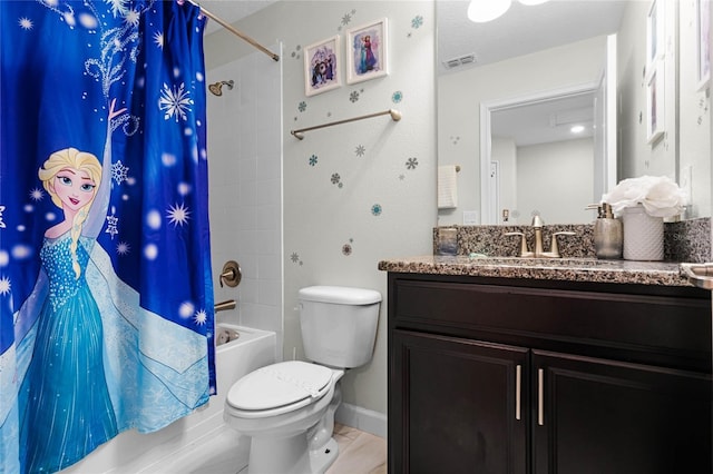 bathroom with toilet, vanity, visible vents, baseboards, and shower / bath combo