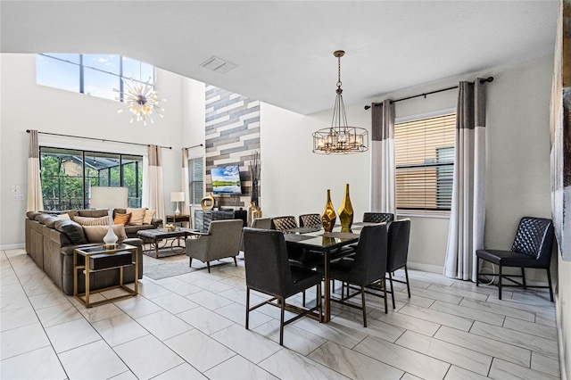 dining area with visible vents, a notable chandelier, and baseboards