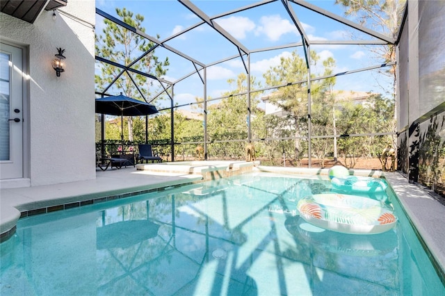 outdoor pool featuring glass enclosure and a patio area