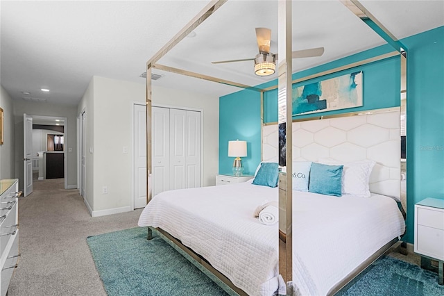 bedroom with a closet, visible vents, dark carpet, a ceiling fan, and baseboards