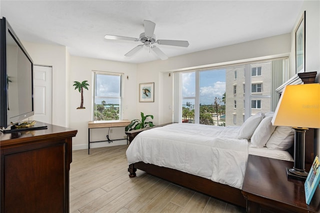 bedroom with access to outside, ceiling fan, light wood-style flooring, and baseboards