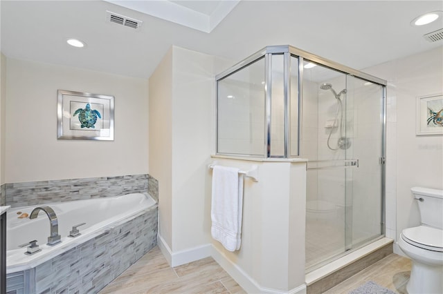 bathroom featuring toilet, a stall shower, visible vents, and a bath