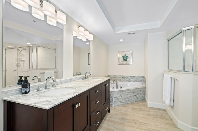 full bathroom featuring a bath, a stall shower, visible vents, and a sink