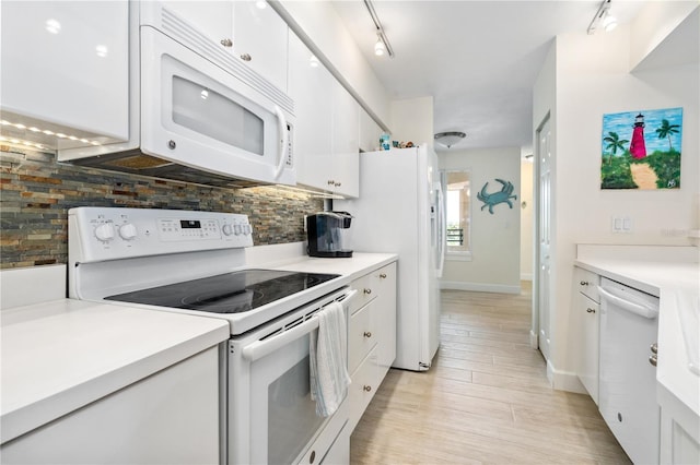 kitchen featuring tasteful backsplash, light countertops, white appliances, and white cabinets