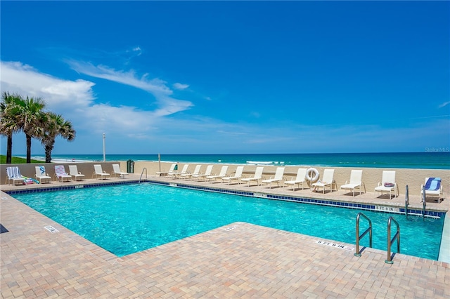 community pool featuring a water view and a patio area