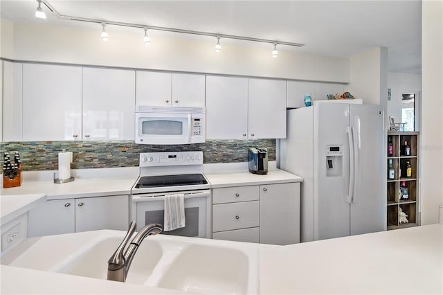 kitchen featuring white appliances, a sink, white cabinetry, light countertops, and tasteful backsplash