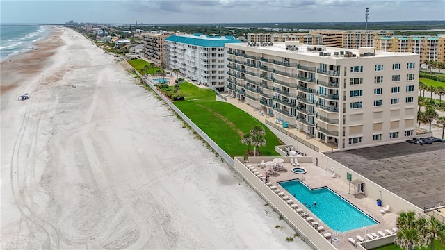 birds eye view of property with a view of the beach, a water view, and a city view